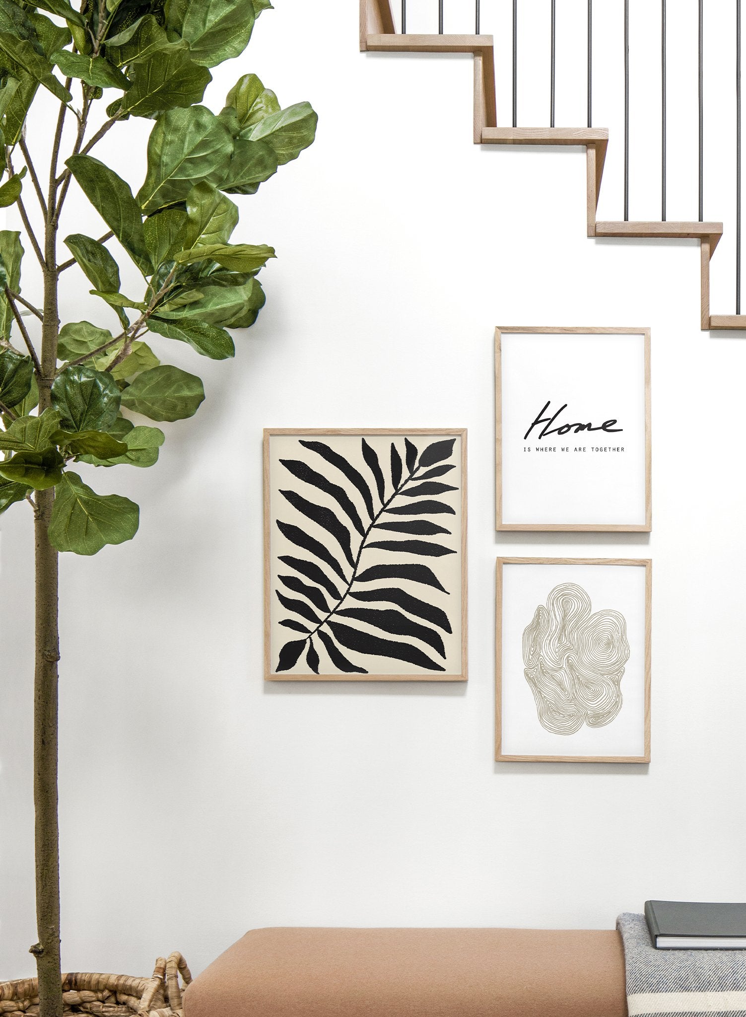 "Minimalist Fern" is a minimalist illustration poster by Opposite Wall in black and beige of an abstract black fern leaf over a beige background inspired by French painter Henri Matisse.