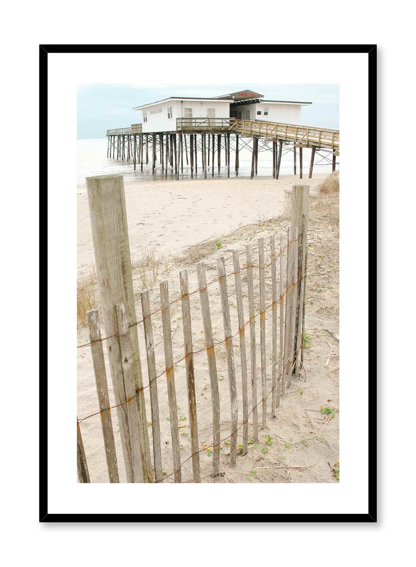 Beach House is a minimalist photography of the perspective of the observer walking down a walkway leading to the beach overseeing a beach house by Opposite Wall.