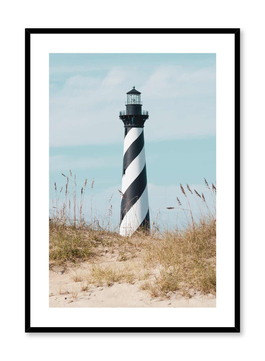 Striped Watchtower is a minimalist photography of a sandy pathway covered in beach grass leading to a swirled black and white tall lighthouse by Opposite Wall.